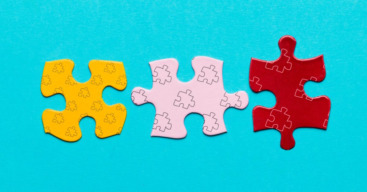 Three puzzle pieces of colours yellow, pink and red respectively