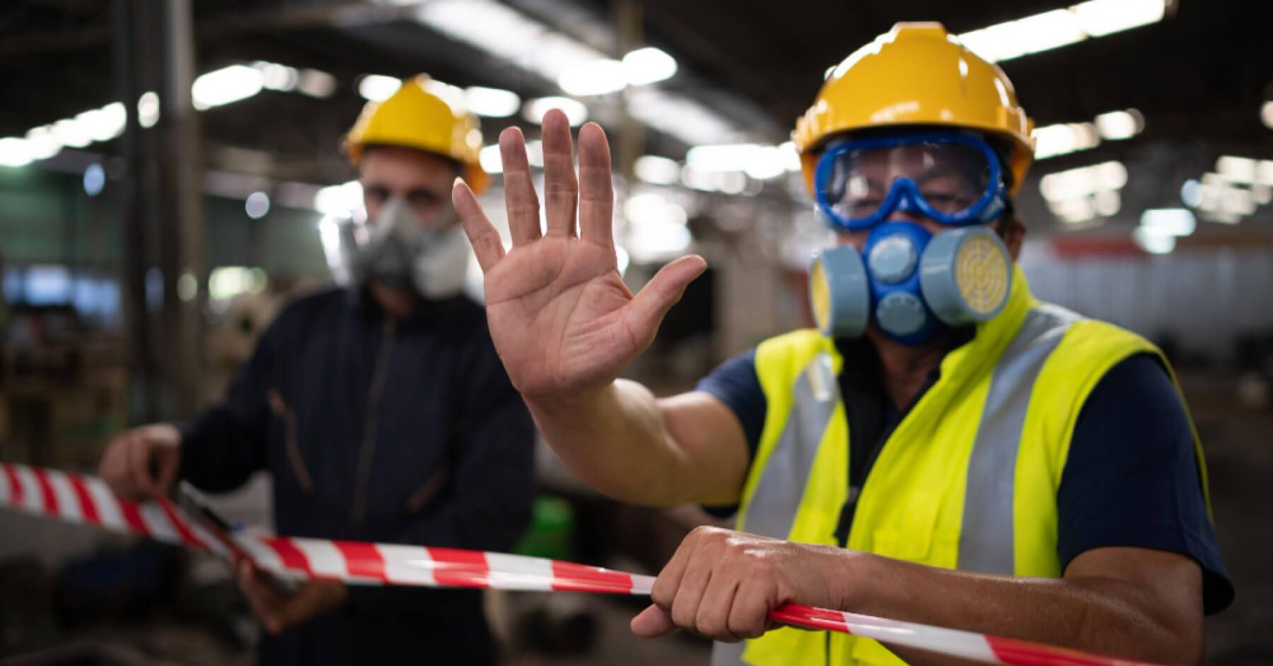 Blue collar worker with gears saying stop
