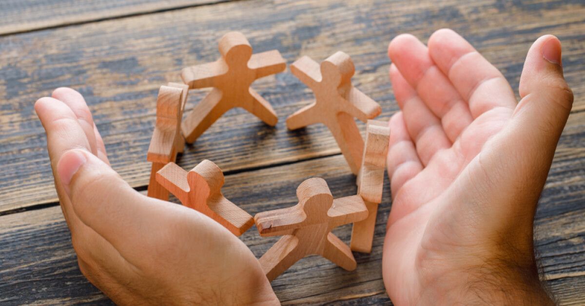 A hand supporting 6 wooden blocks