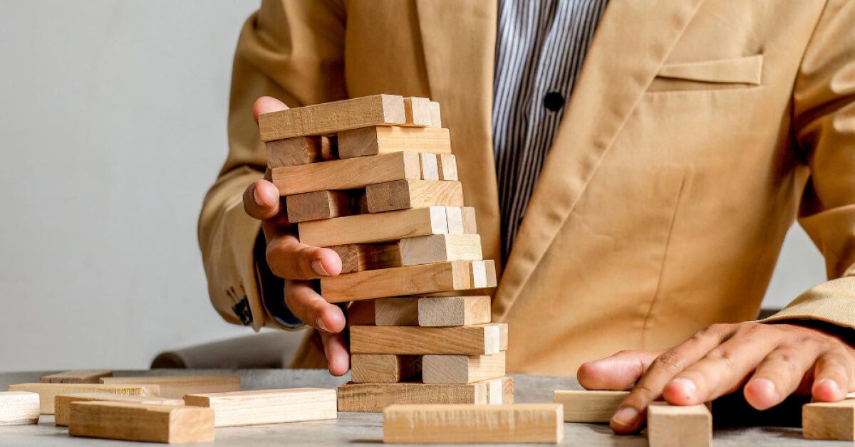 Employee catching a falling jenga