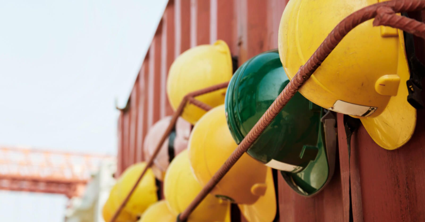 Helmets of workers aligned