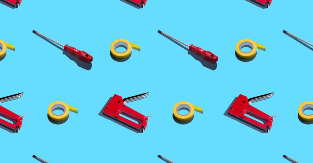 Tape and tools against a blue background