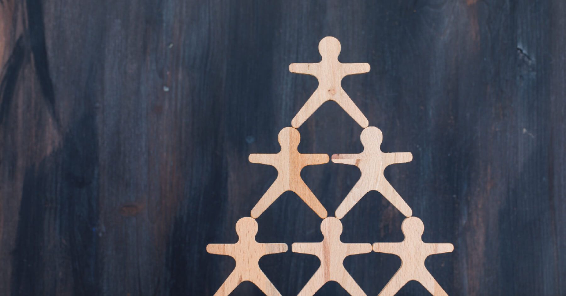 Wooden stick men stacked on top of each other