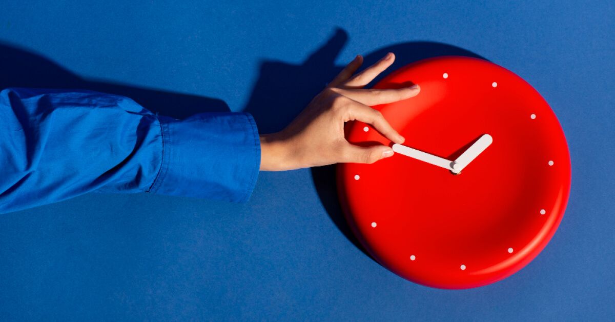 Woman holding a red clock's hand