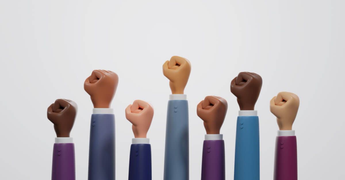 Hands of various colours raised in union