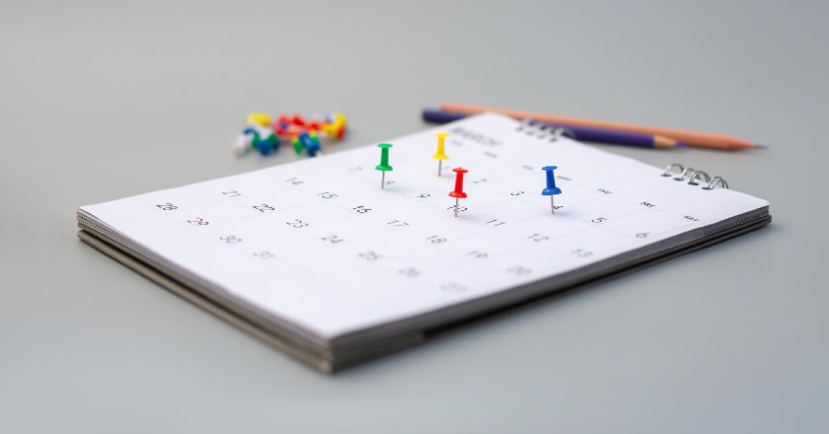 Multicolored pins on a calendar