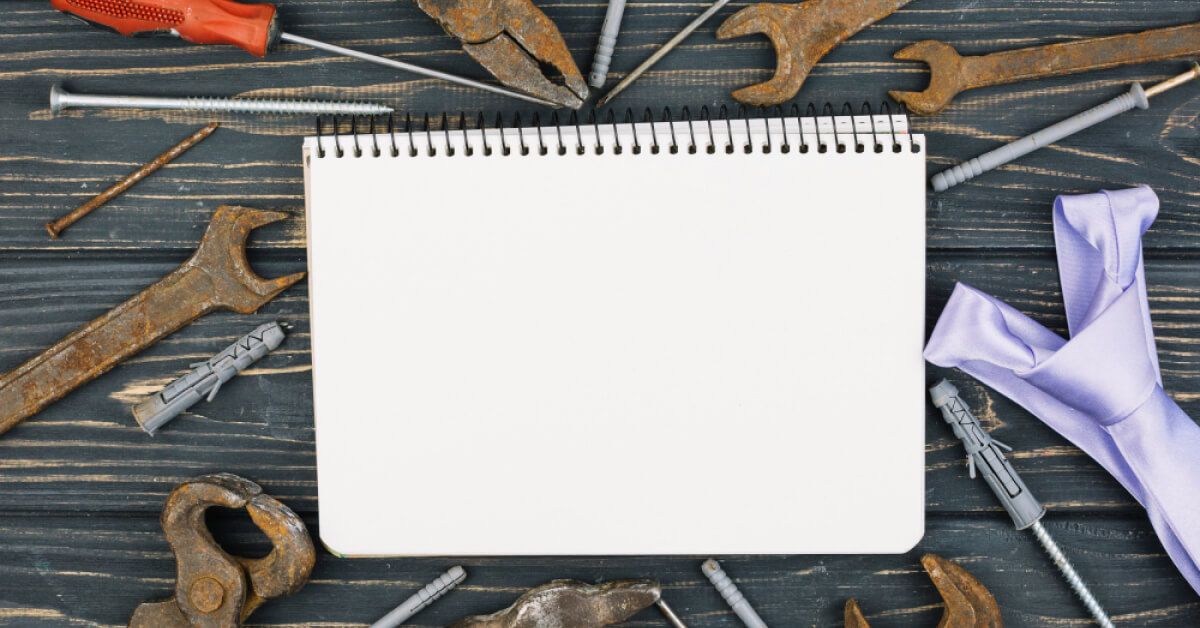 Notepad with tools around it