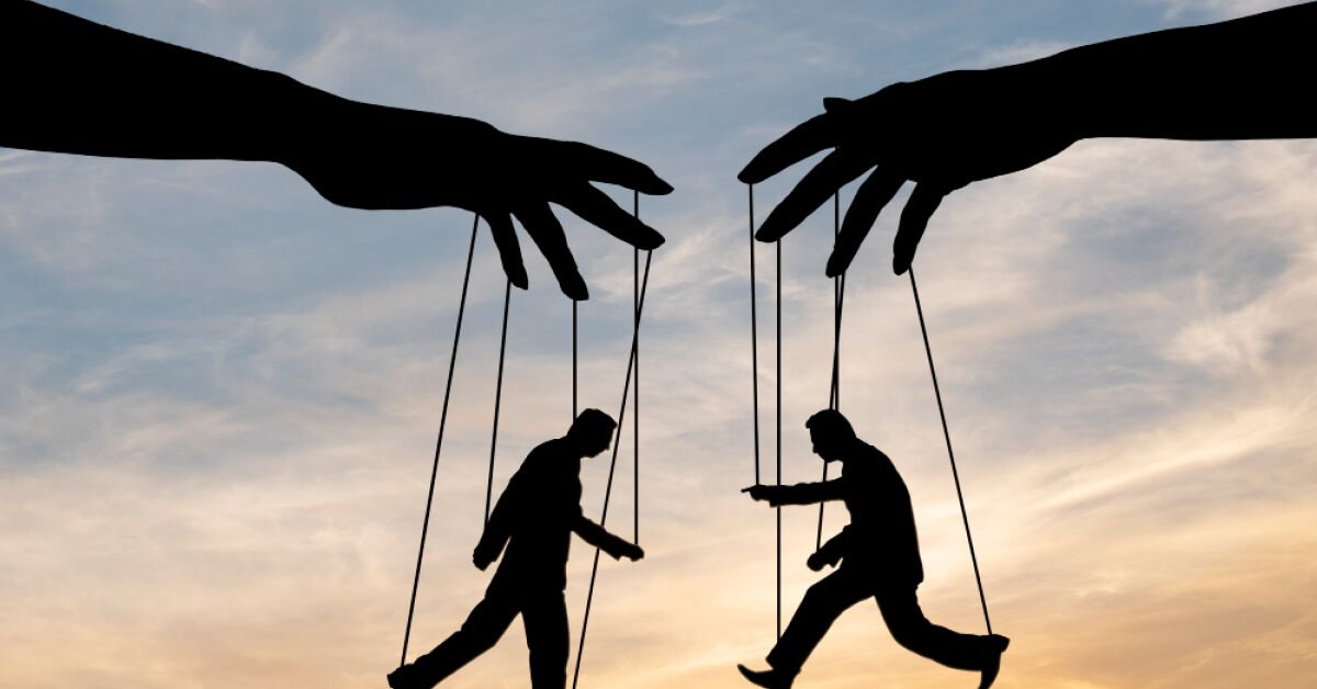 Silhouettes of two puppets being handled