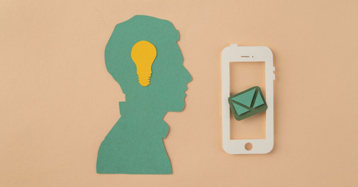 Paper cutout of person with yellow lightbulb and phone with message