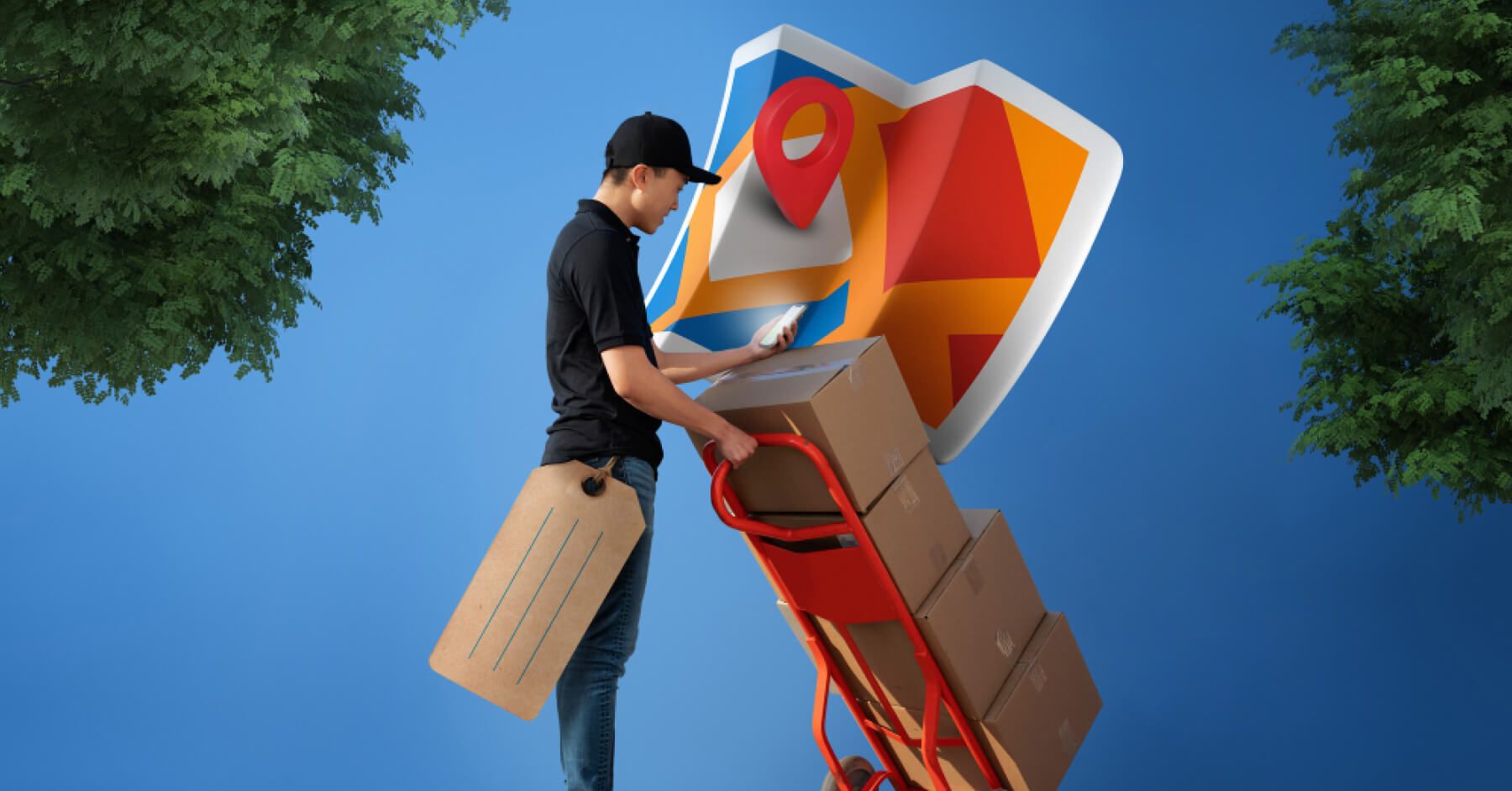 Logistics employee holding a phone and a cart with boxes