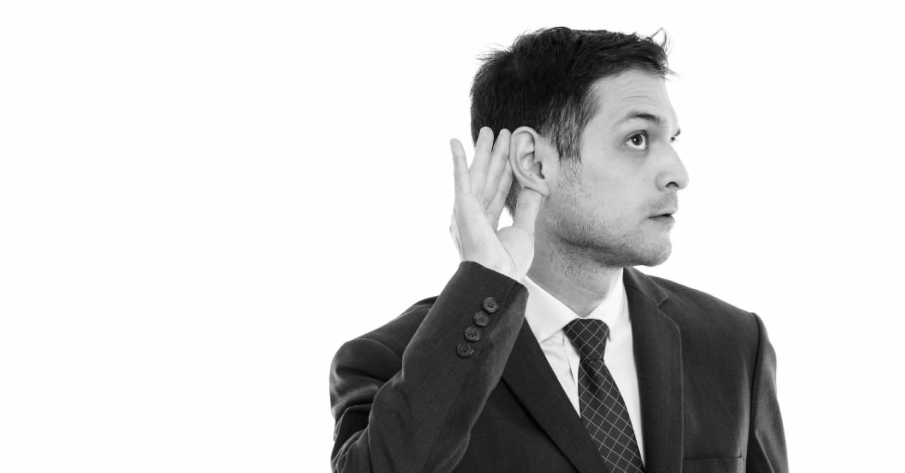 Person holding their ear to listen accurately