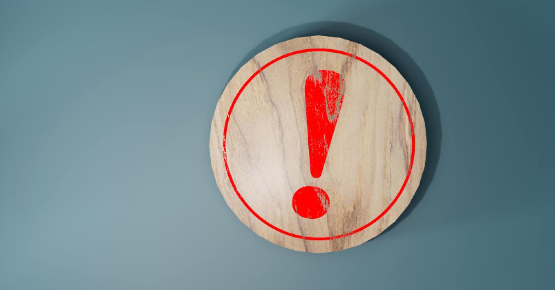 Wooden chip with red exclamation mark