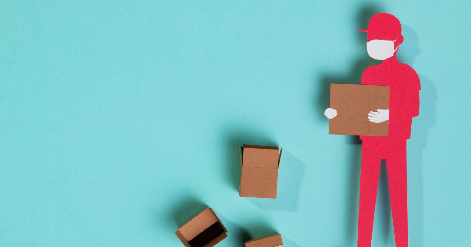 Paper cutout of logistics employee with cartons