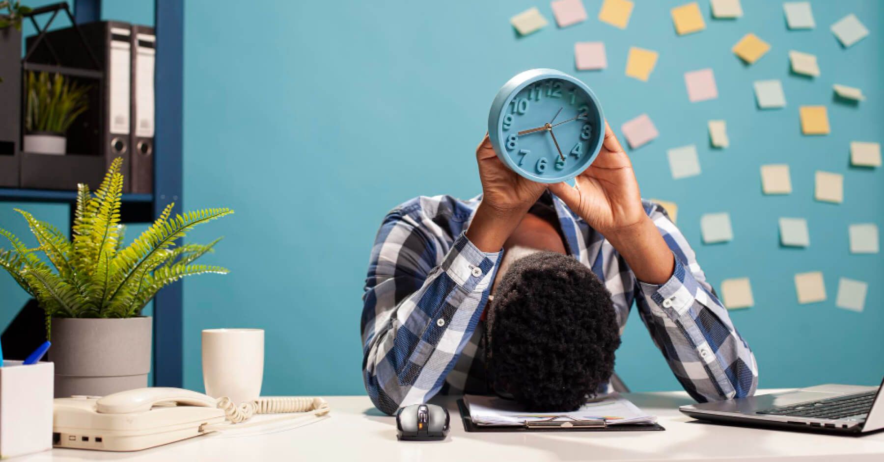 Burnt out employee with a clock over their head