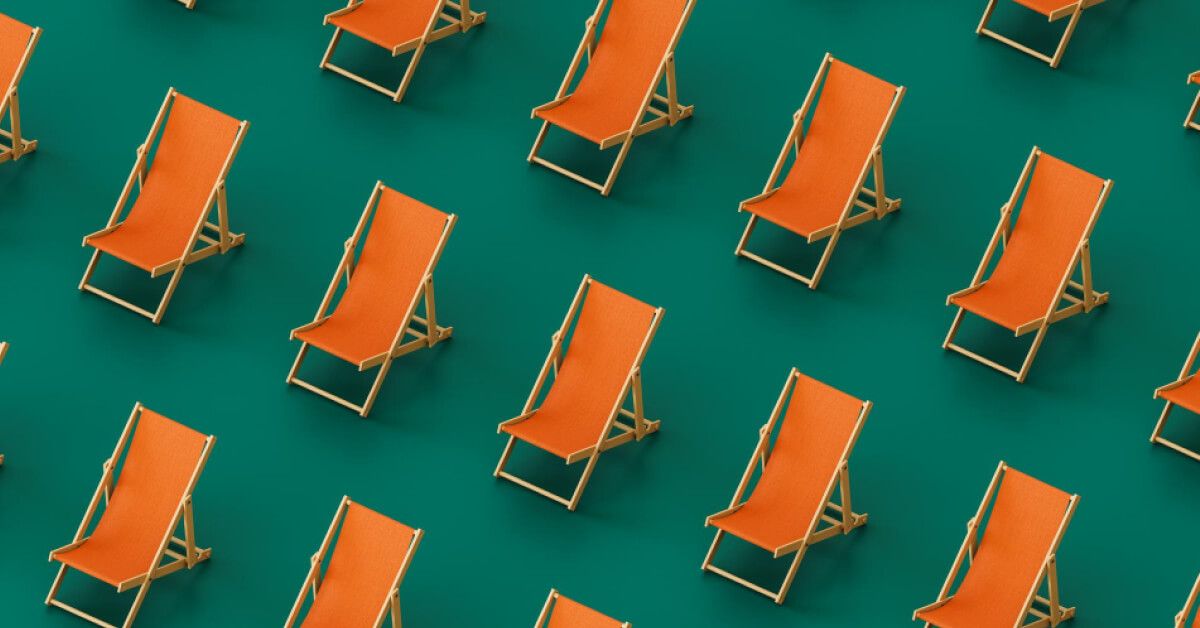 Orange beach relaxing chairs aligned next to each other