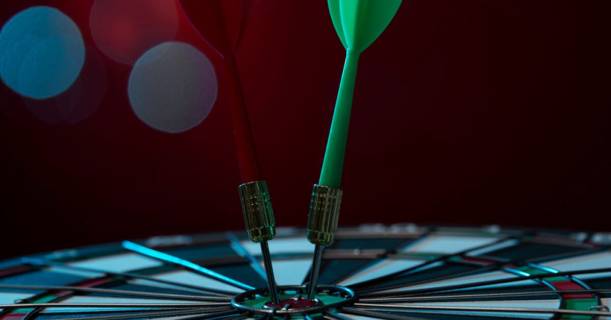 Two darts hitting bullseye