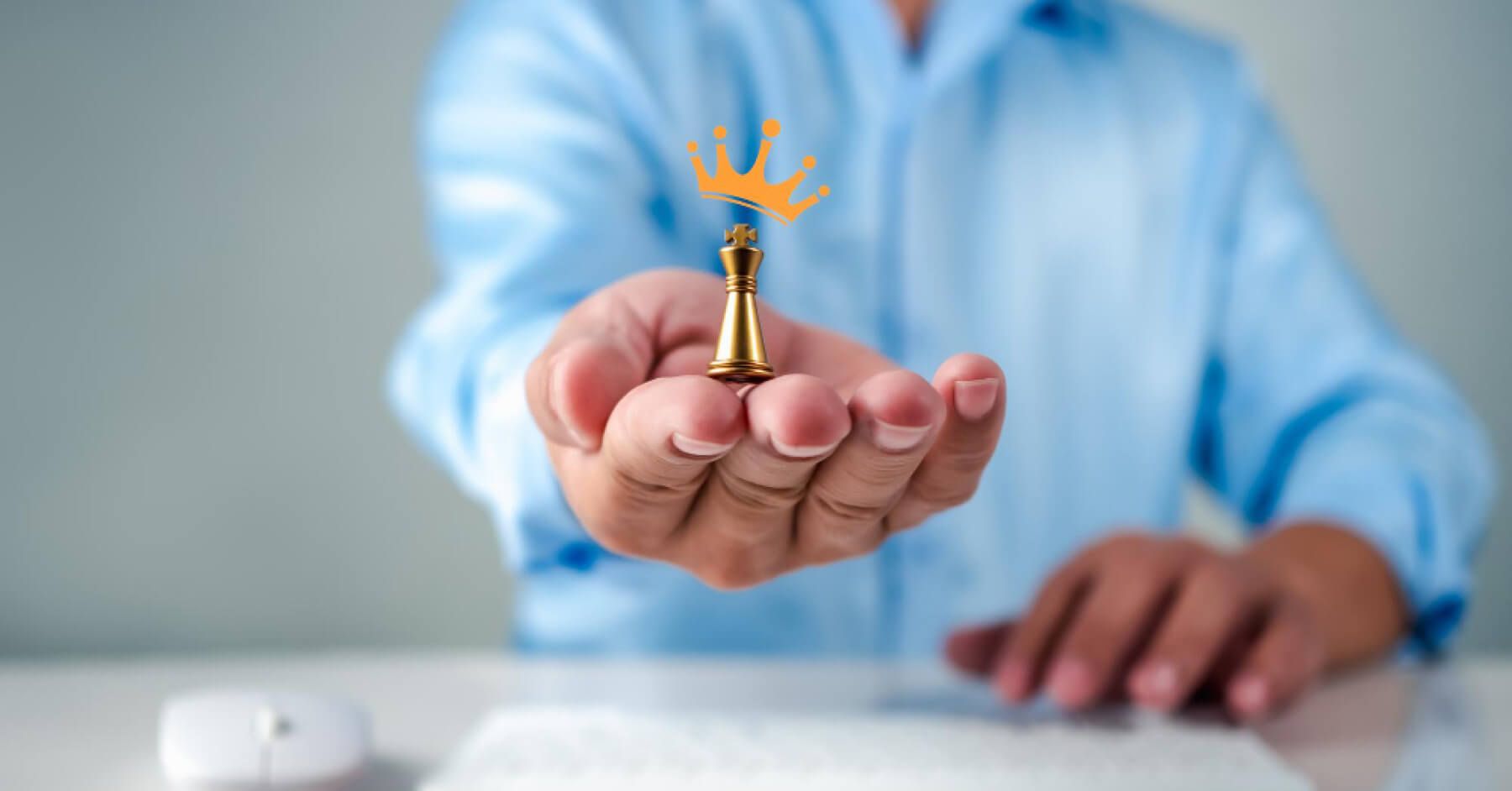 Employee holding a golden chess pawn with a crown