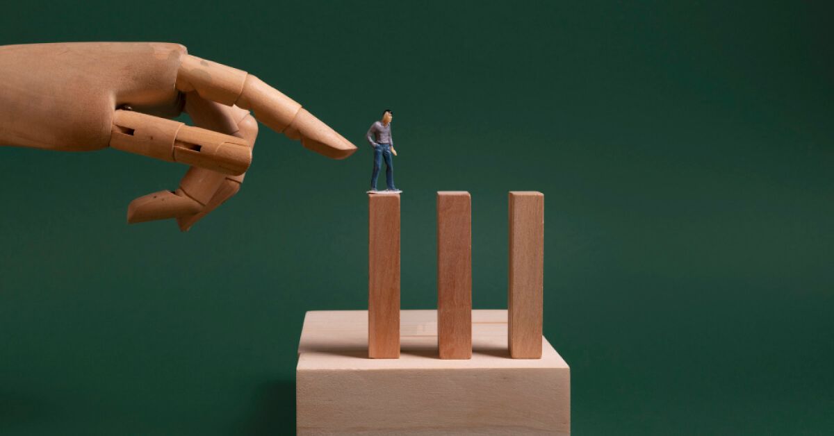 Toy hand pushing a toy man walking on wooden blocks