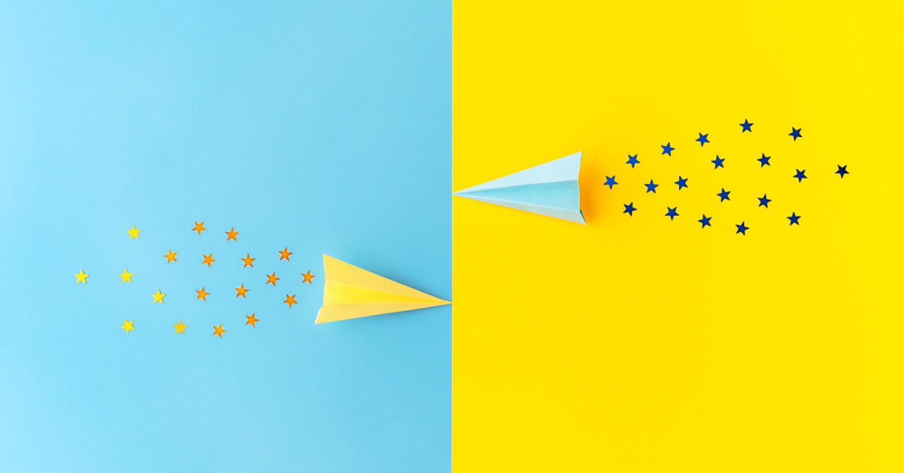 Two airplanes of blue and yellow colours against each other with star glitters 