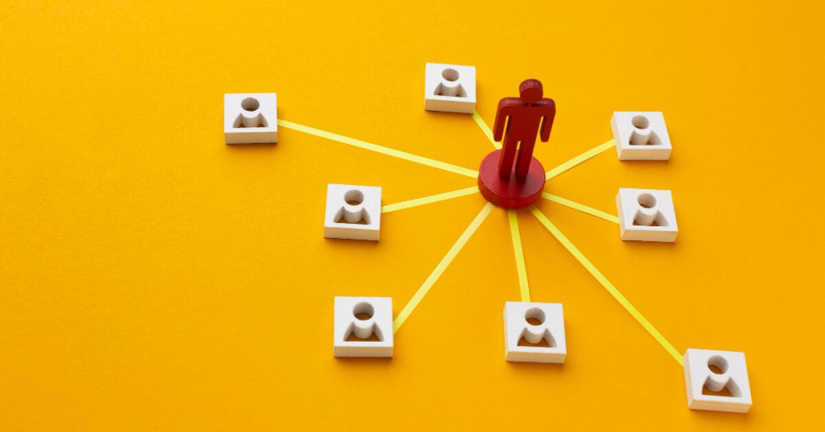 Red human toy being interconnected with other employee blocks surrounding it