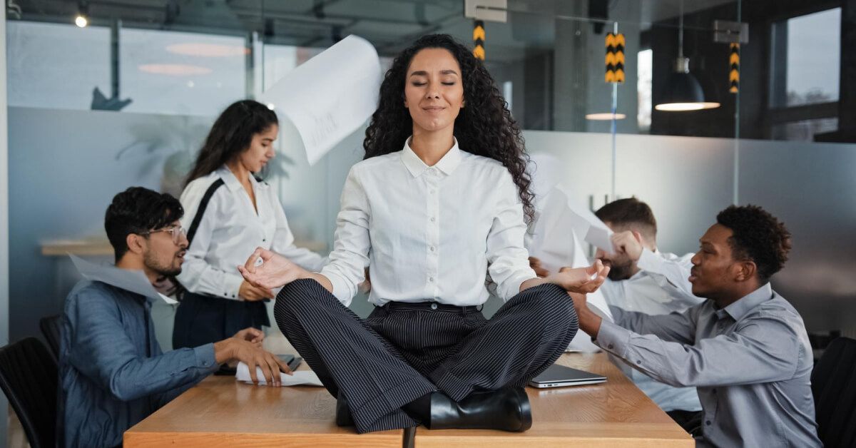Employee relaxing amidst her chaotic team