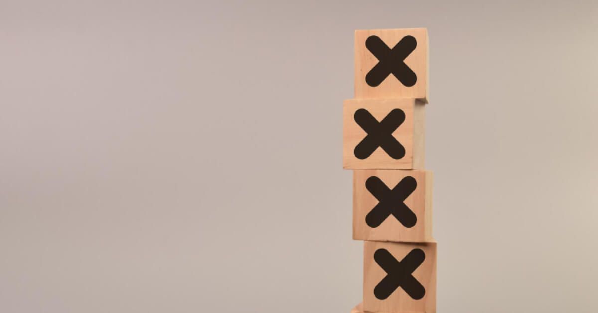 Wooden blocks with the sign X topped on each other
