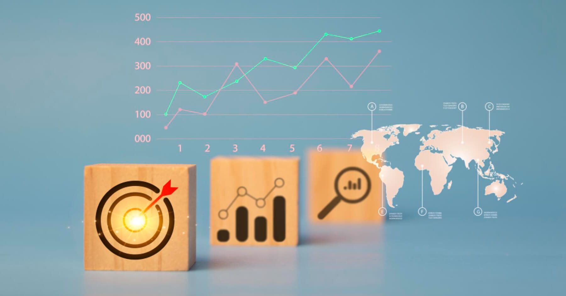 Wooden blocks of aim, target and graph against a world map background