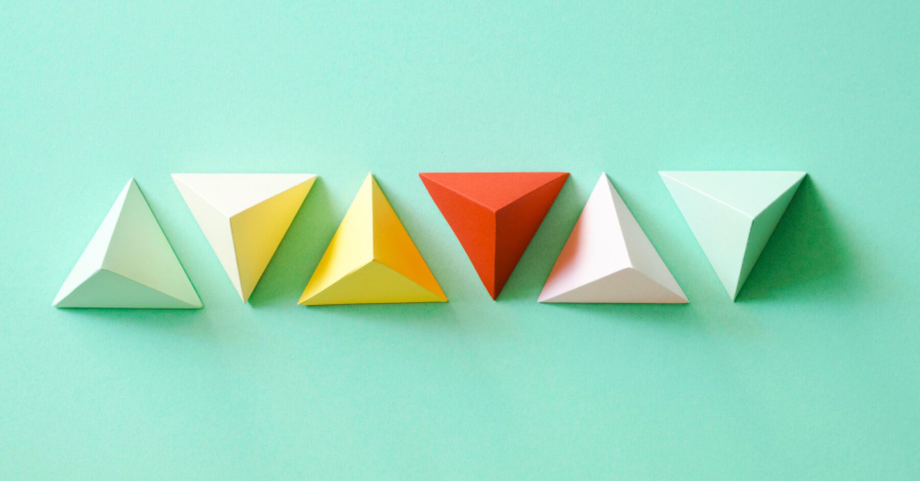 Five different colours of triangular things lines next to each other