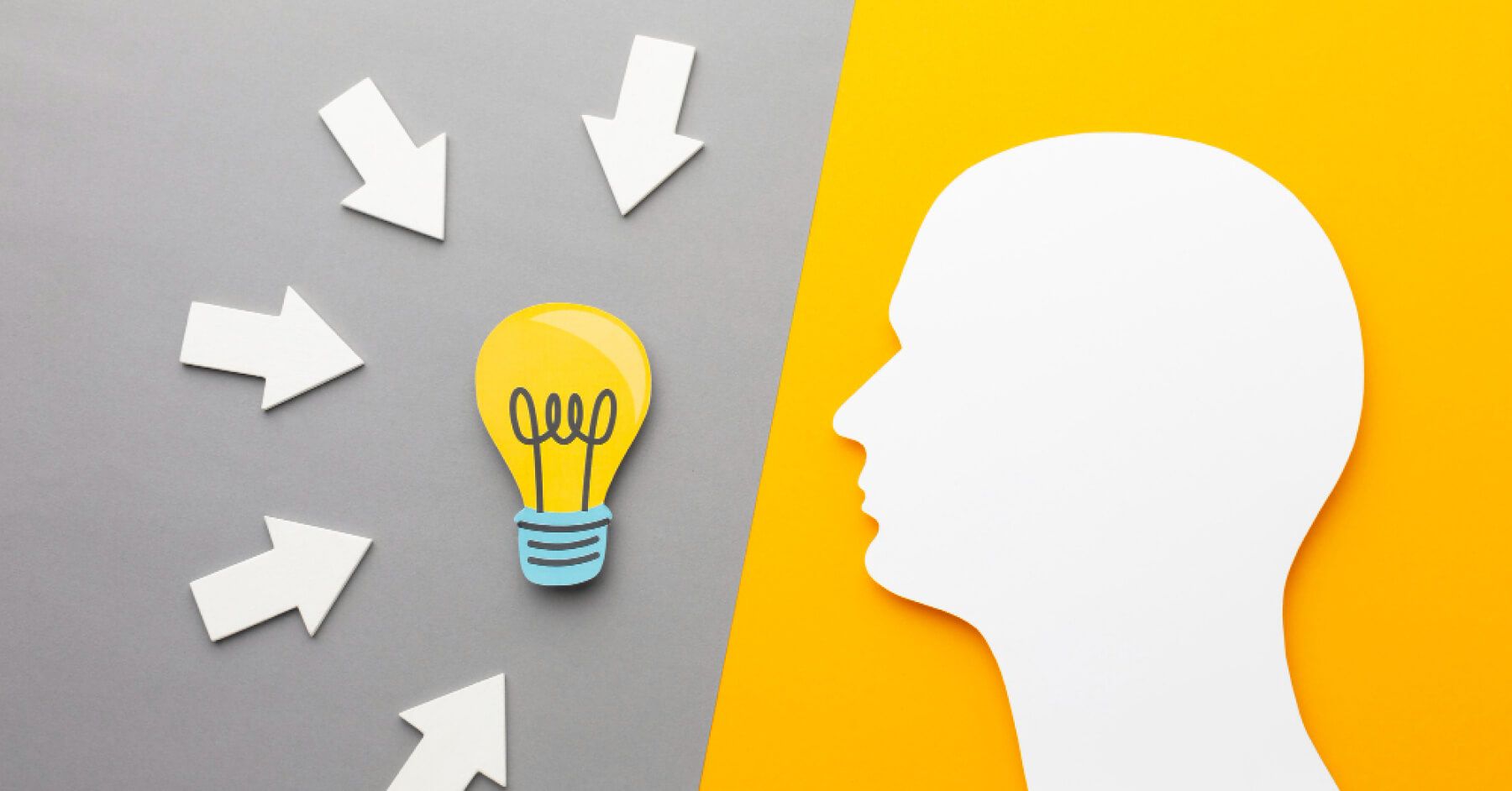 Paper cuts of a person and a light bulb arrows