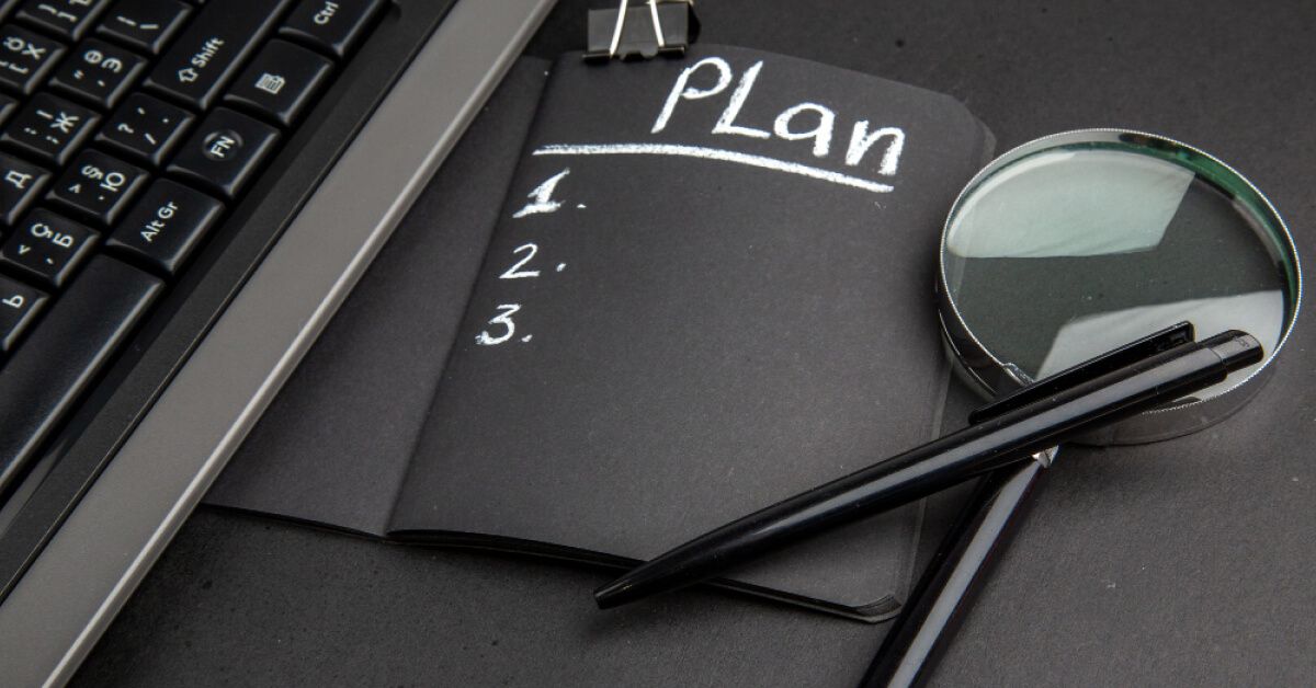Black notebook and magnifying glass