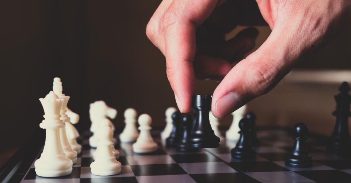 a person moving a chess piece - soldier 