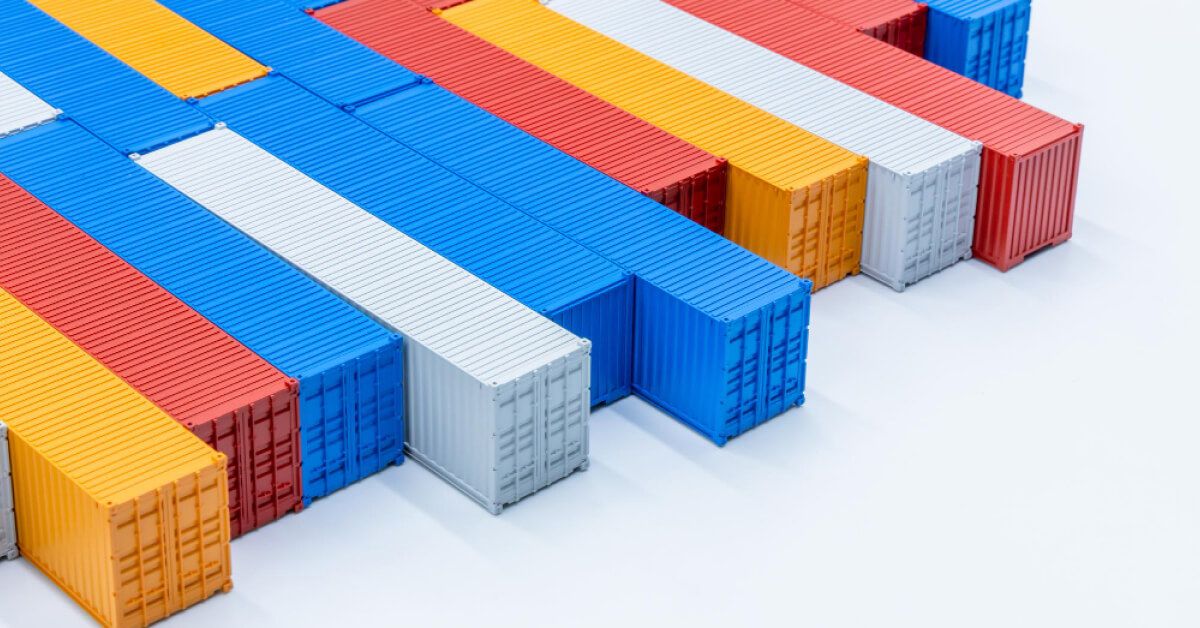 Containers of various colours stacked against a white background