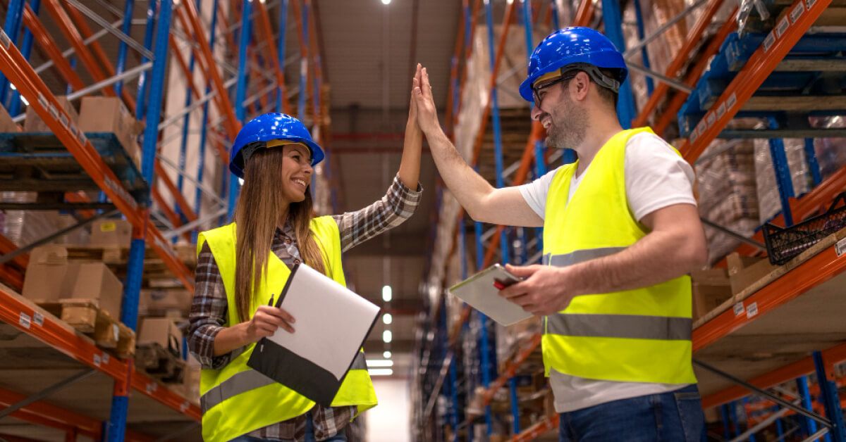 Logistics workers hi-fying each other
