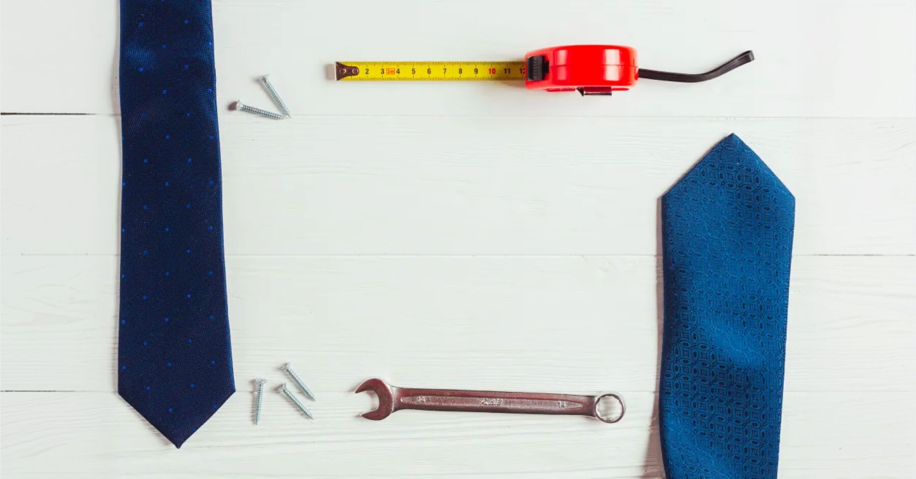 Manufacturing tools and ties against a wooden background