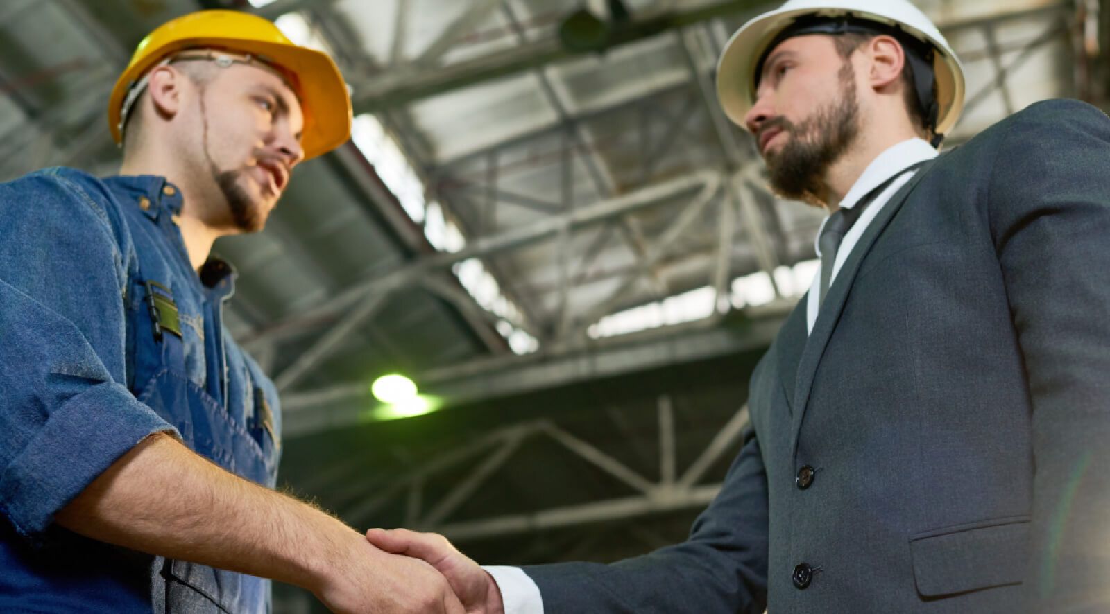Manufacturing workers shaking hands