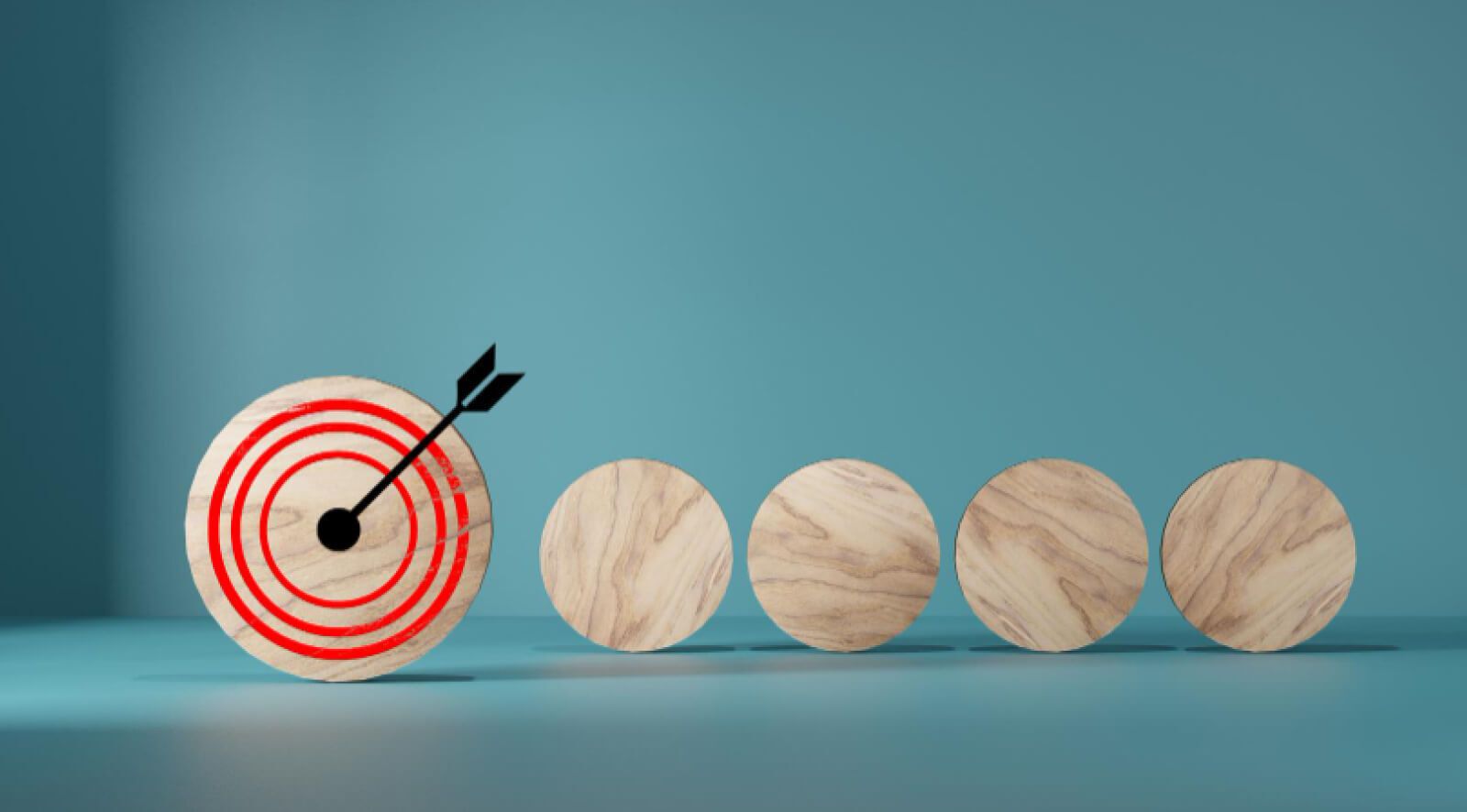 5 wooden circles with one with a arrow on the bullseye 