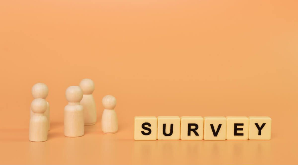 board game pawns and wooden blogs spelling "Survey"