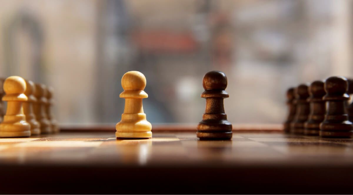 two chess pawns facing each other