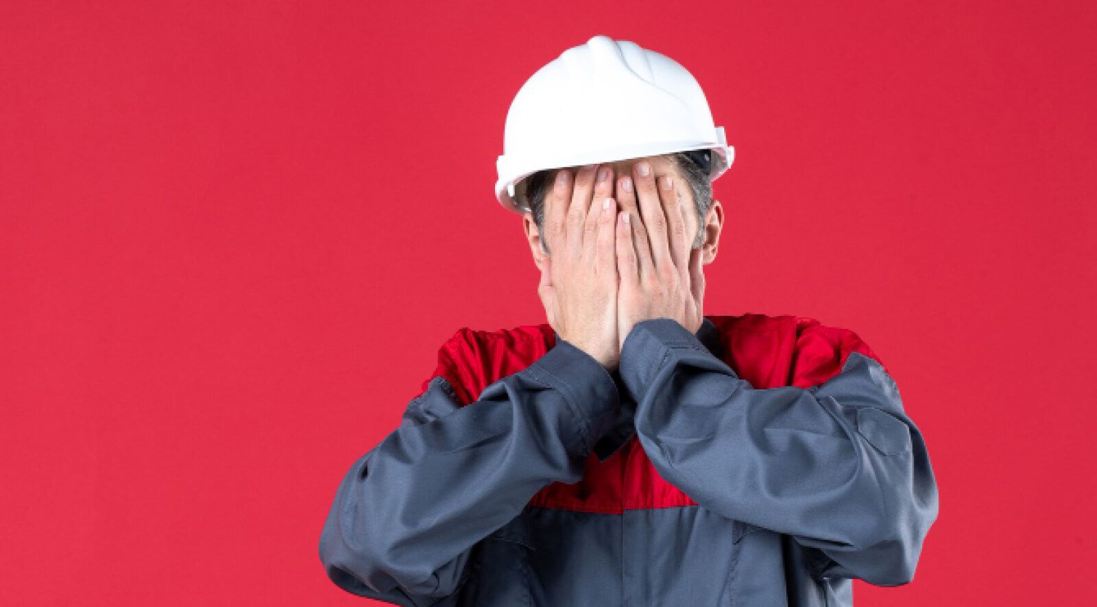 worker holding his face