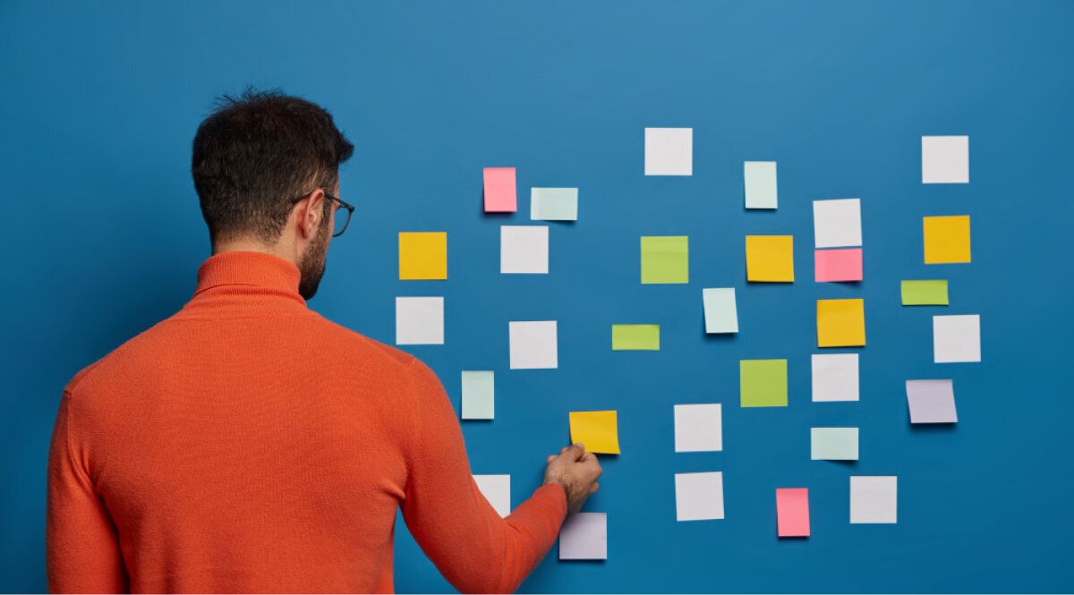 a man sticking sticky notes