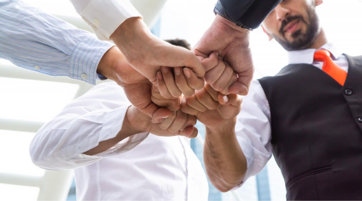 Employees fist-bumping