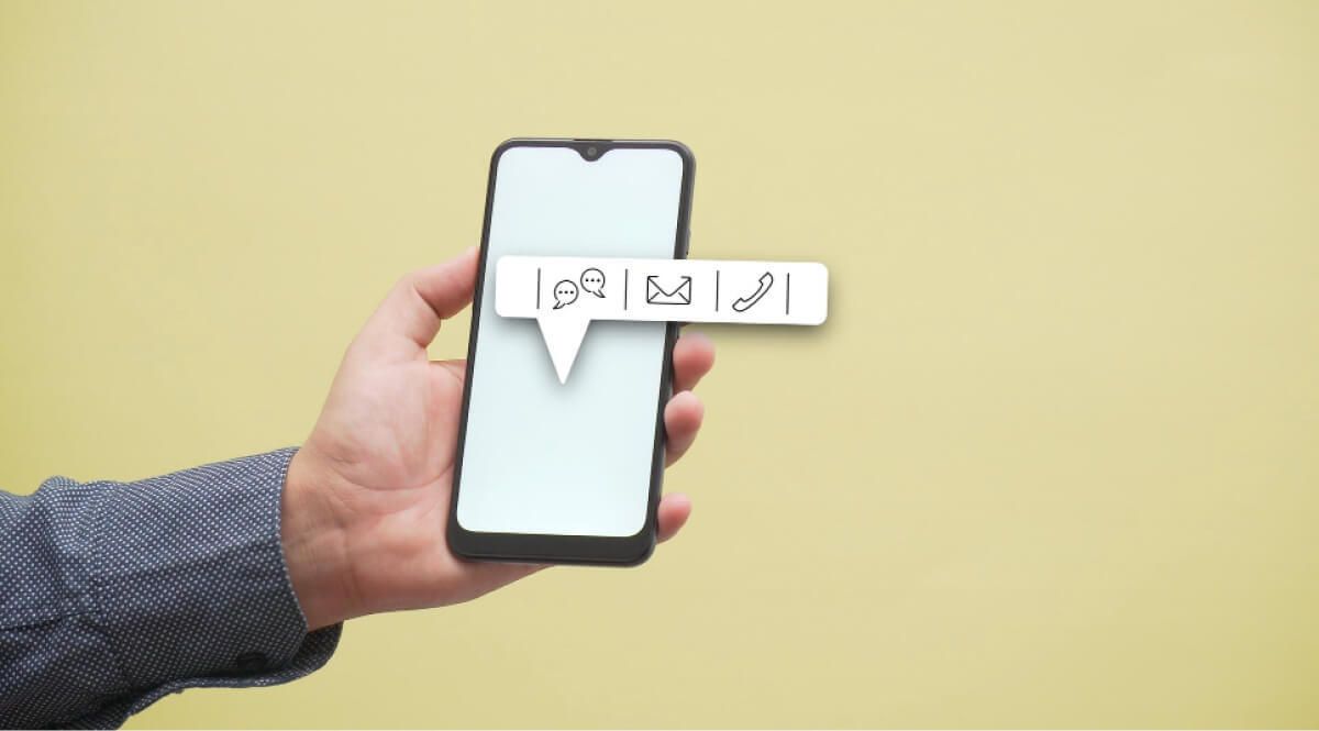 A man holding a phone with message, email and call options popping out