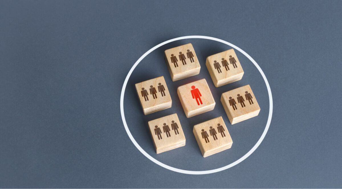 Wooden block of people with a big red man in a wooden block in a circle