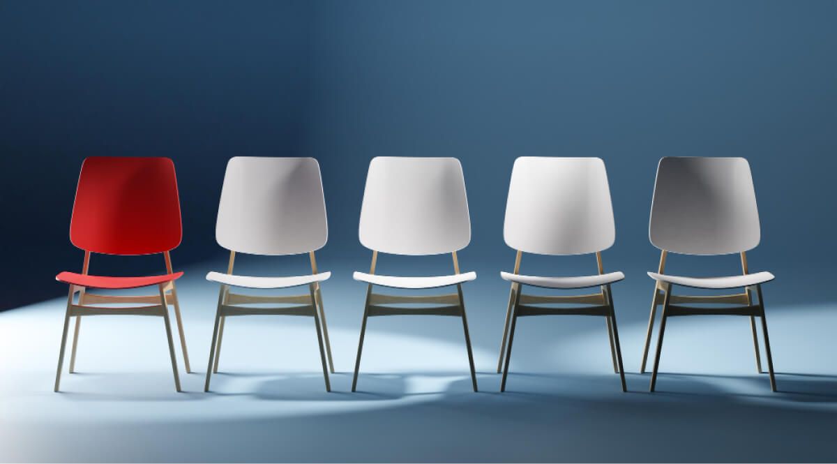 Chairs with a red chair and all of the rest being white