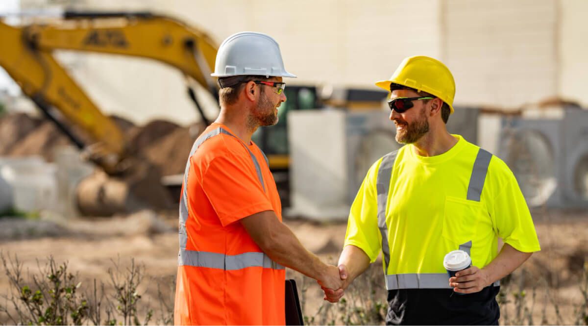 Construction workers shaking hands