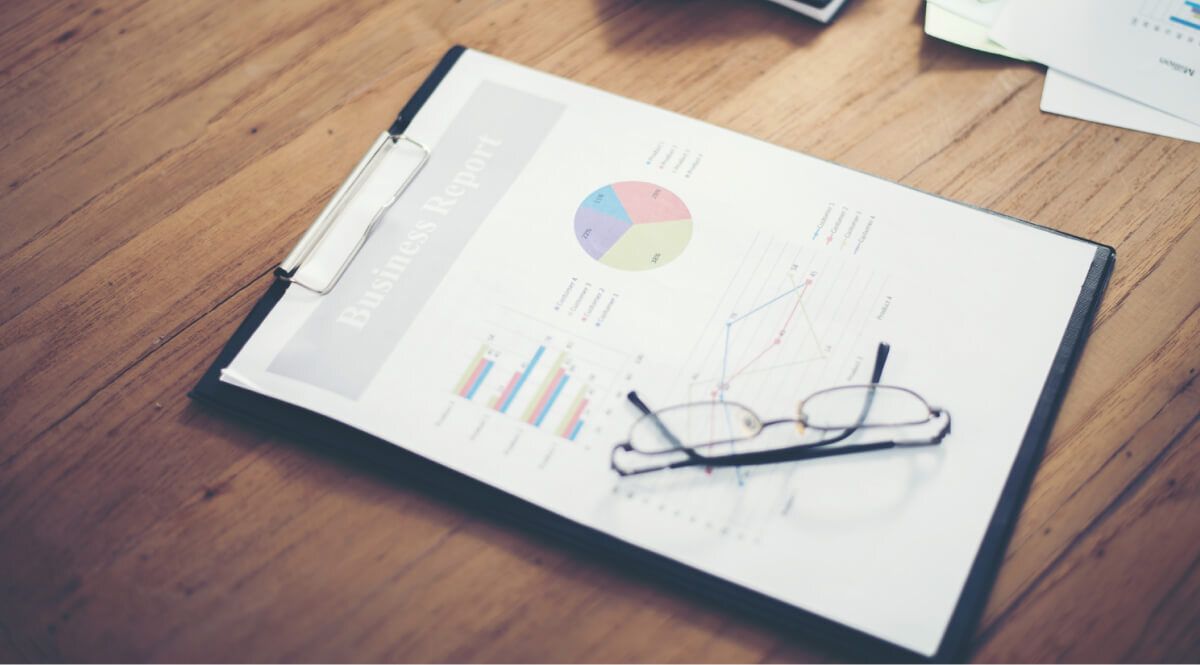 Reports with reading glasses on top of them