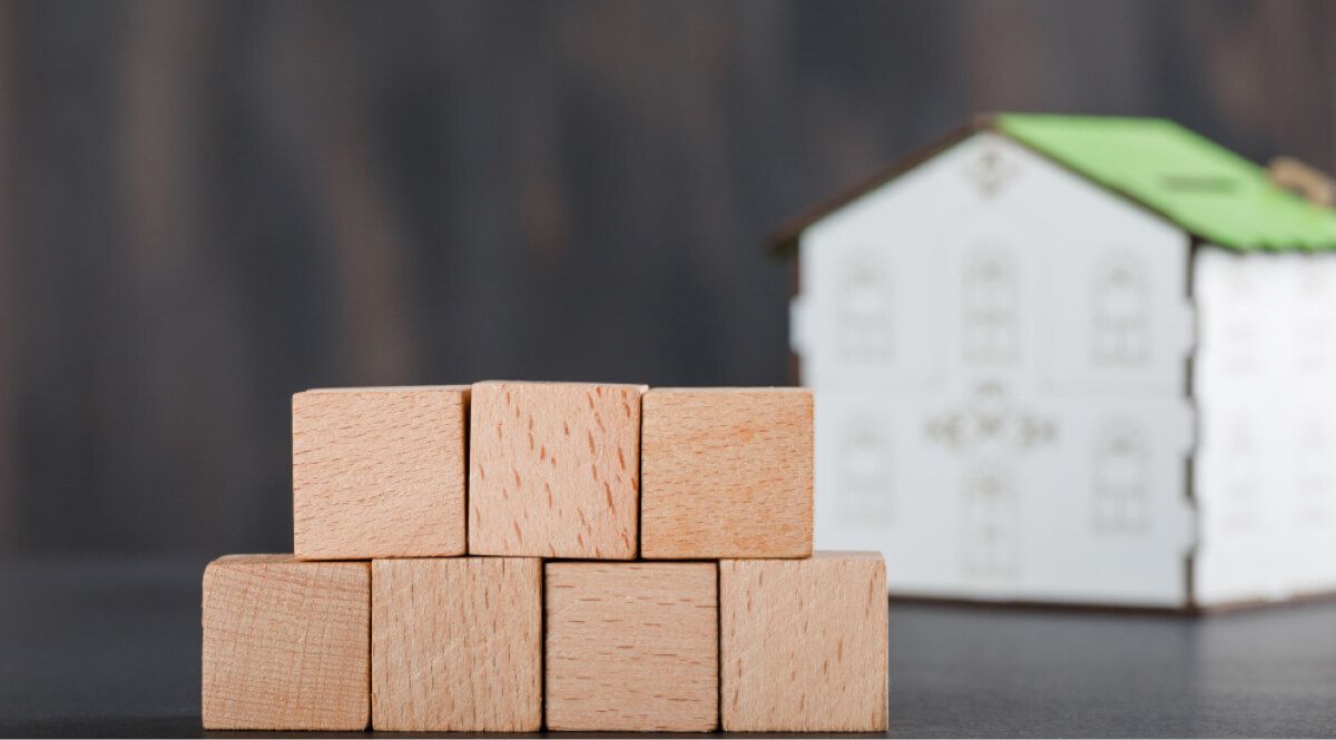 wooden block placed in front of a mode house