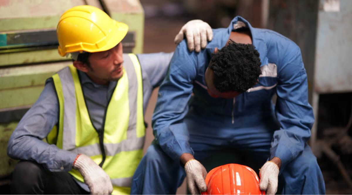 Contractor feeling sad and fellow worker consoling him