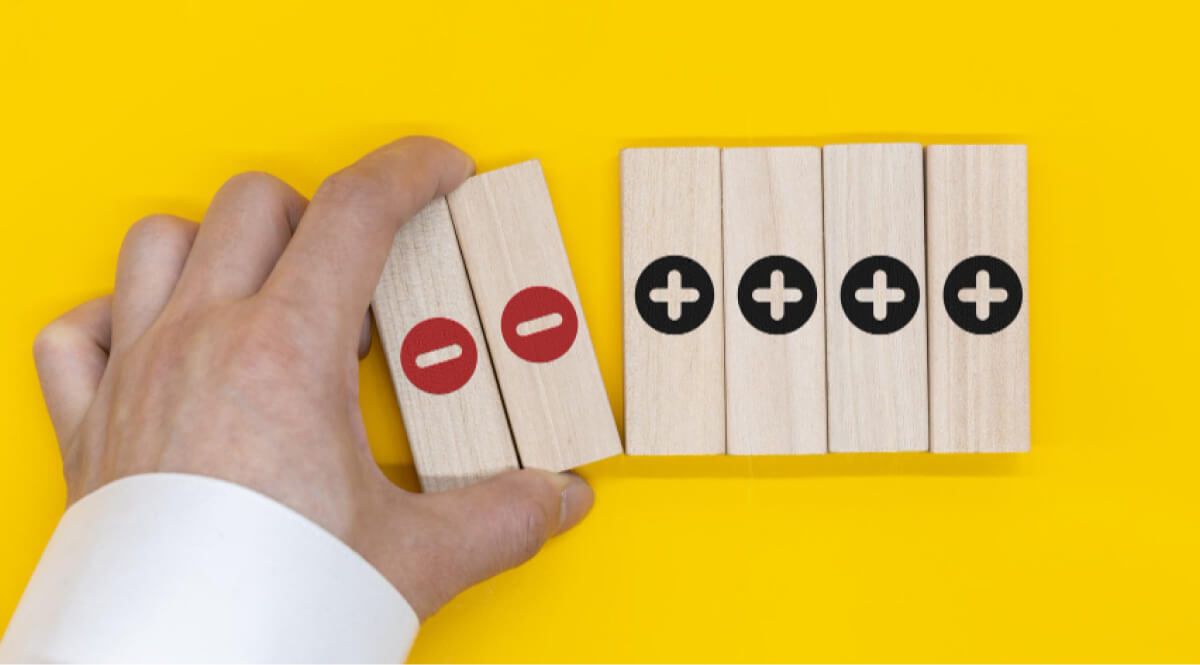 Man separating minus wooden blocks from plus wooden blocks