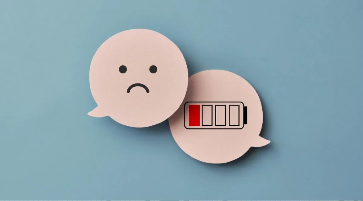 Wooden clouds of a sad emoji and a low battery